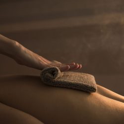 therapist-massaging-woman-s-back-with-hot-towel-spa-less